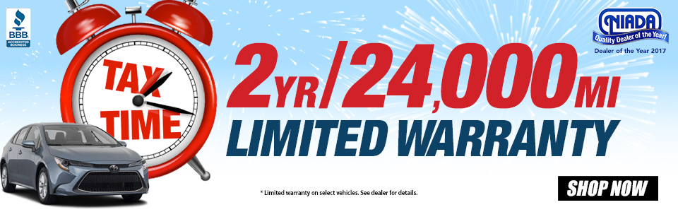 black vehicle with clock that says tax time. Text displays two year, 24,000 mile limited warranty.