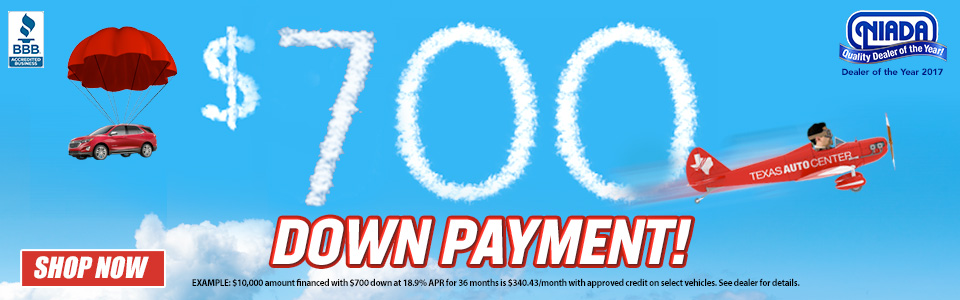 Airplane spelling out $700 Down Payment in skywriting.